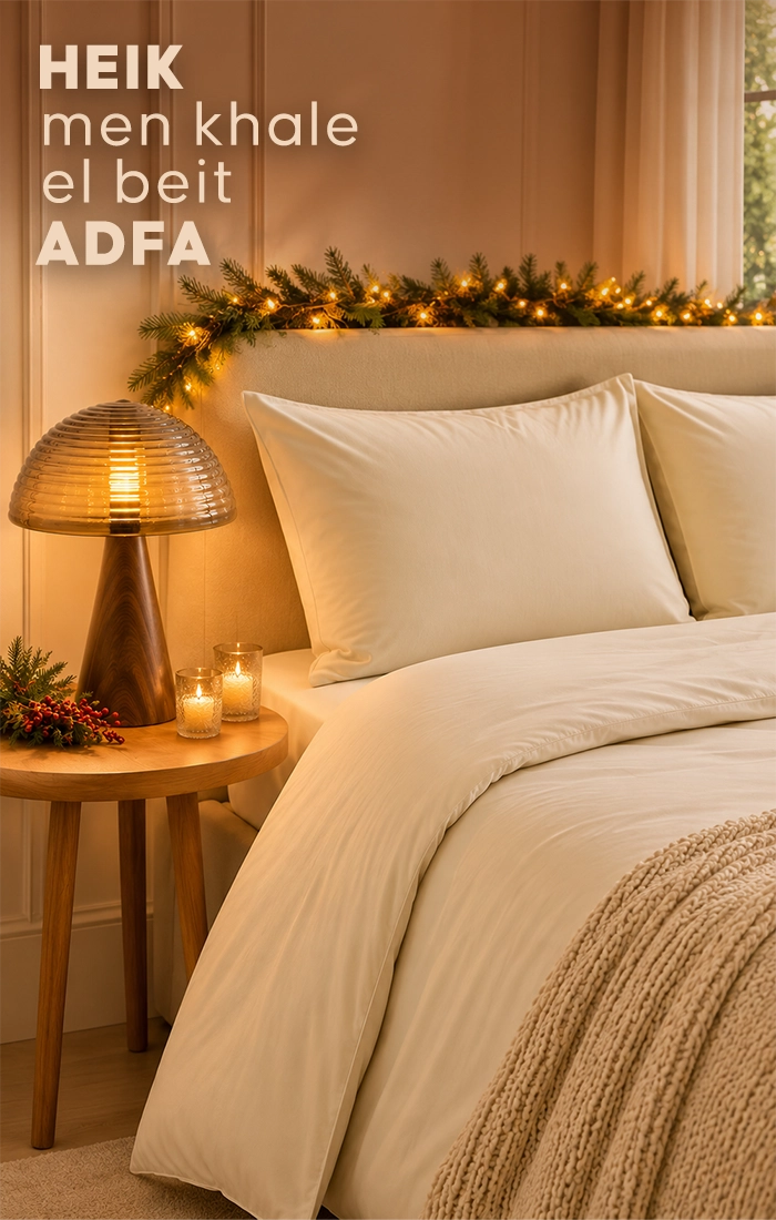 Elegant bedroom featuring a bed dressed in soft dusty blue textured bedding with matching pillows, wooden bedside tables, warm ambient lighting, natural decor and a woven.