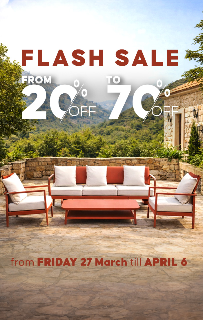 Outdoor garden lounge set with sofa, chairs and coffee table on a scenic terrace.