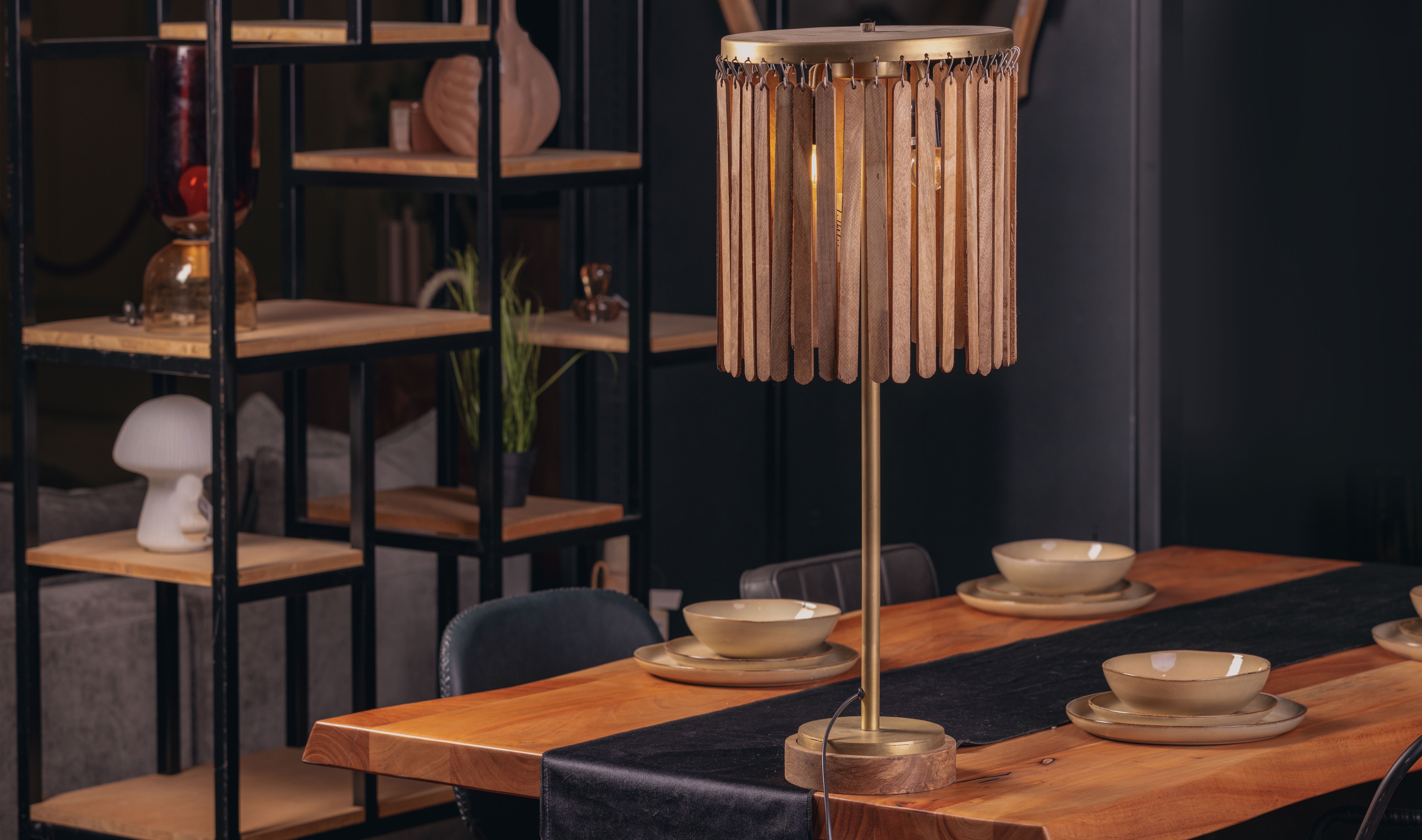 Sculptural lighting piece placed on a wooden dining table.