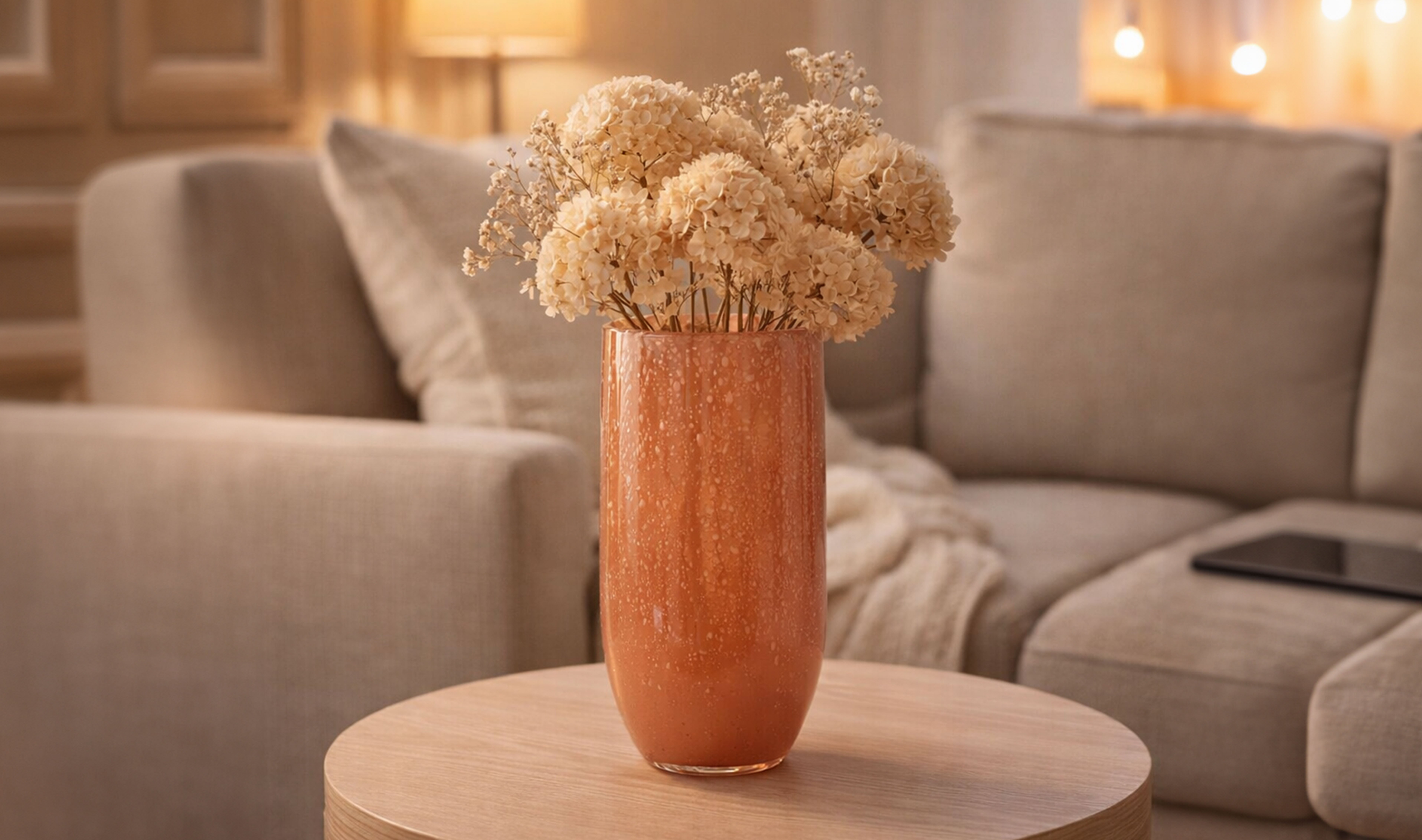 Decorative vase with dried flowers on a side table.