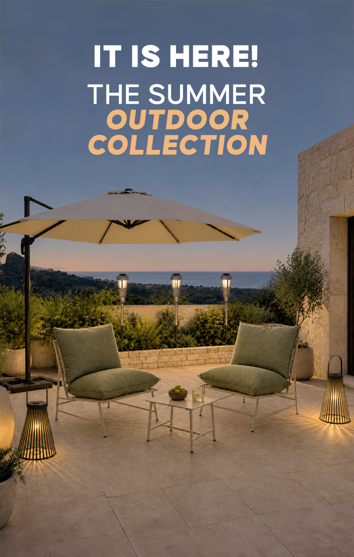 A luxury outdoor patio at dusk featuring the "Summer Outdoor Collection" text overlay. The scene includes two sage green cushioned lounge chairs, a cream cantilever umbrella, and decorative lantern lighting.