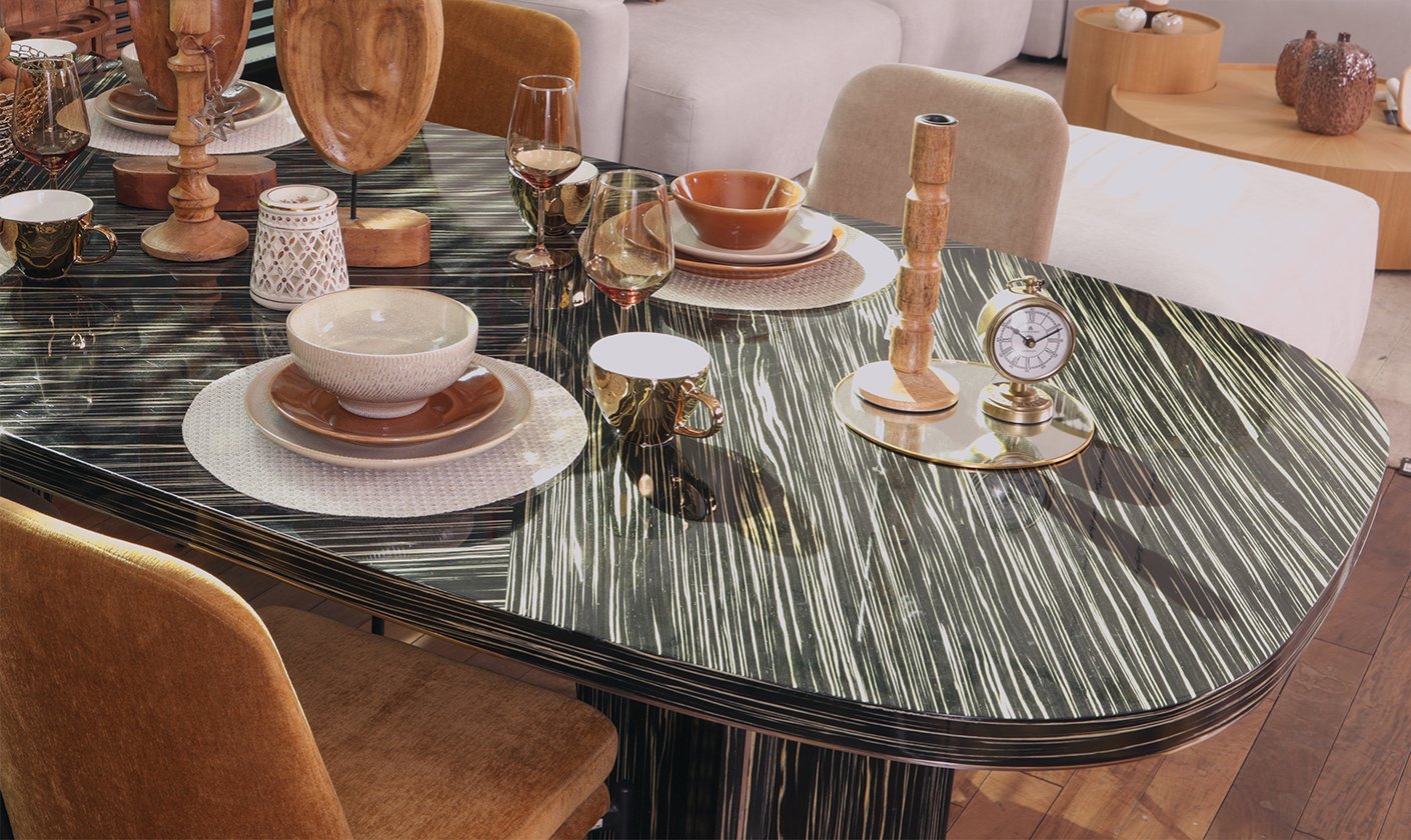 Elegant dining room setup with marble dining table, upholstered chairs, and modern d&eacute;cor.