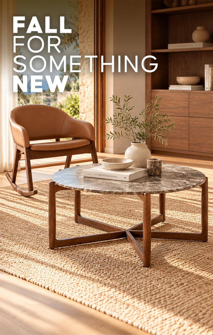 : leather rocking chair and marble-top coffee table with walnut base in a sunlit living room
