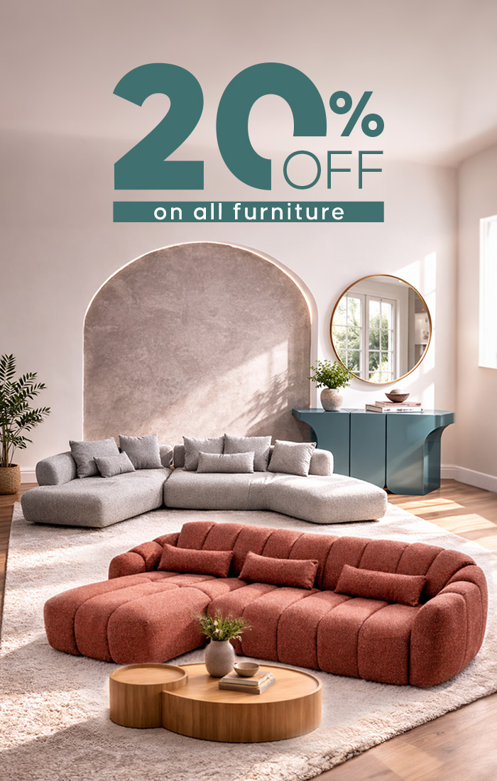 Bright modern living room with curved sofas, a round mirror, blue console table and wooden coffee tables.