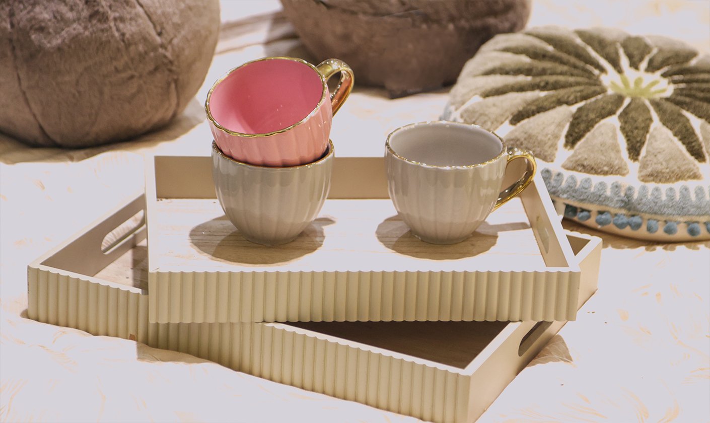 Breakfast tray with cups and table accessories styled for a warm morning setup.