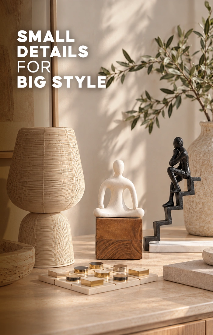 Elegant home d&eacute;cor accessories displayed on a wooden table, featuring a textured beige table lamp, decorative mirror, marble board game, white abstract sculpture, and black figurine in a bright modern living room.