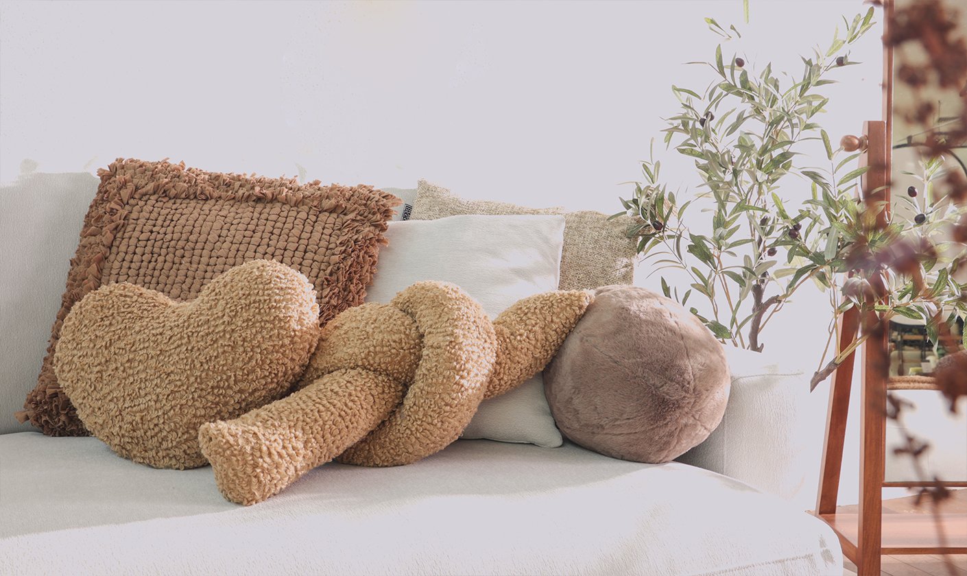 Decorative cushions and textured accent pillows styled on a modern sofa.